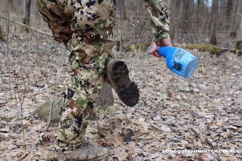 Hunters covers his boots with deer scent
